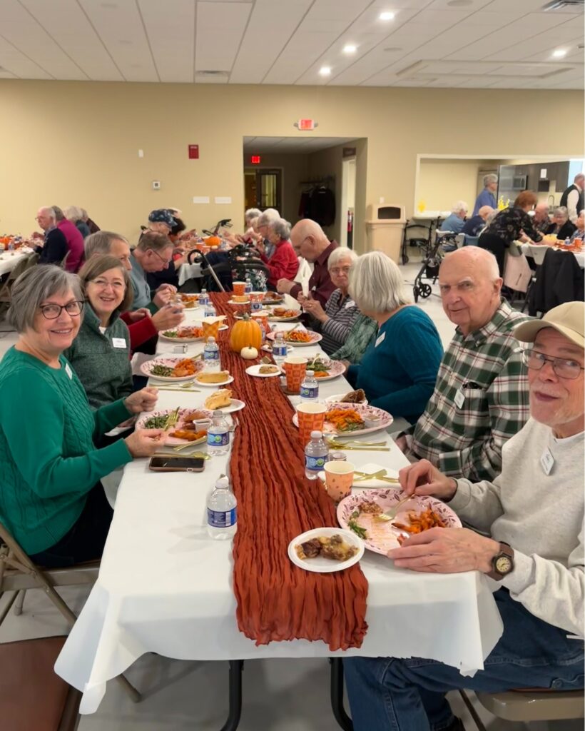 Seniors enjoying a meal in a senior living community 